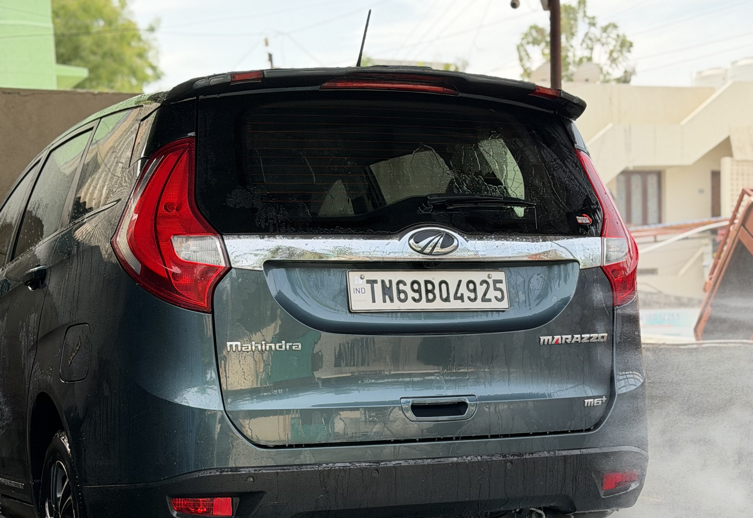 Technician inspecting car paint with flashlight